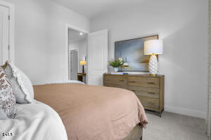 1111 Masters Place Way Durham, NC 27703 - Photo 18 of 37 a bedroom with a bed and a lamp on dresser
