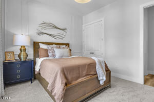 1111 Masters Place Way Durham, NC 27703 - Photo 19 of 37 a bedroom with a bed and a lamp