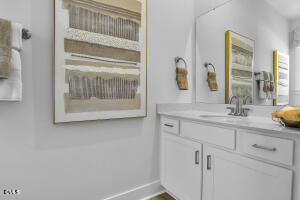 1111 Masters Place Way Durham, NC 27703 - Photo 26 of 37 a bathroom with a sink and a mirror