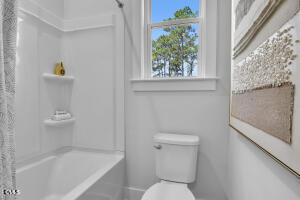 1111 Masters Place Way Durham, NC 27703 - Photo 27 of 37 a white toilet sitting next to a bath tub