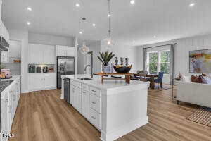 1111 Masters Place Way Durham, NC 27703 - Photo 7 of 37 a large kitchen with stainless steel appliances a lot of counter space and a wooden floors