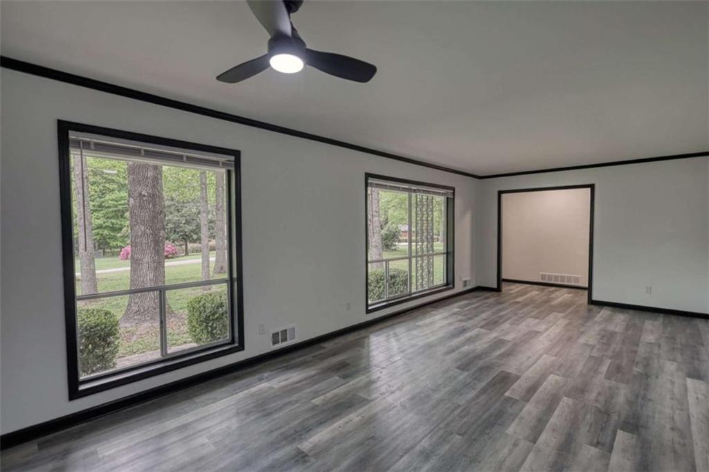 555 Joy Street Jackson, GA 30233 - Photo 12 of 56 a view of an empty room with wooden floor and a window