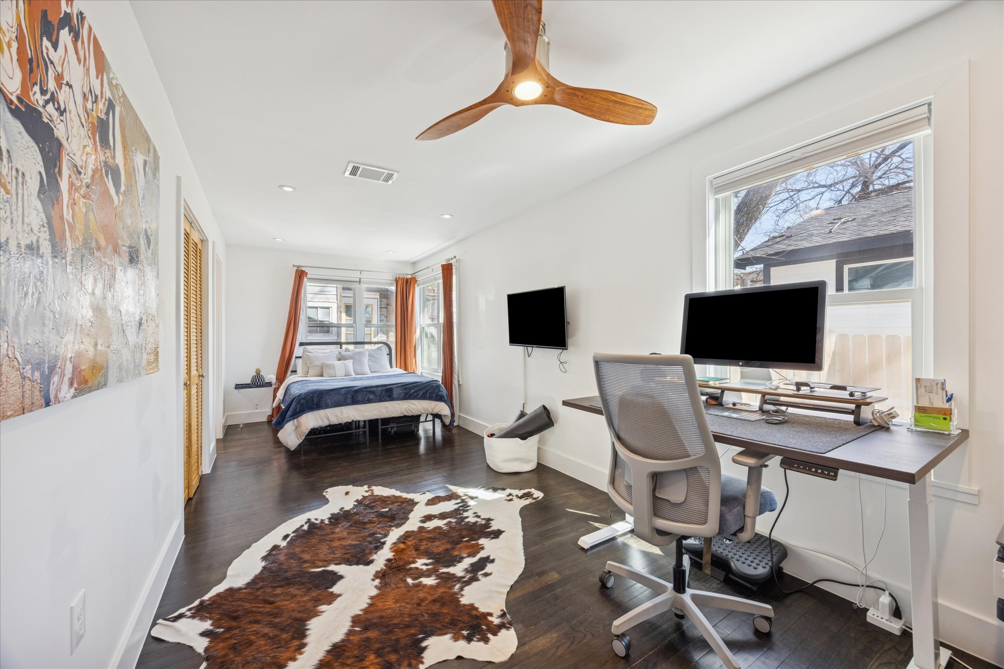 2306 Santa Maria Street Austin, TX 78702 - Photo 8 of 17 a view of a workspace with furniture and a flat screen tv