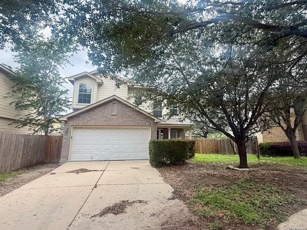 a front view of house with yard and trees