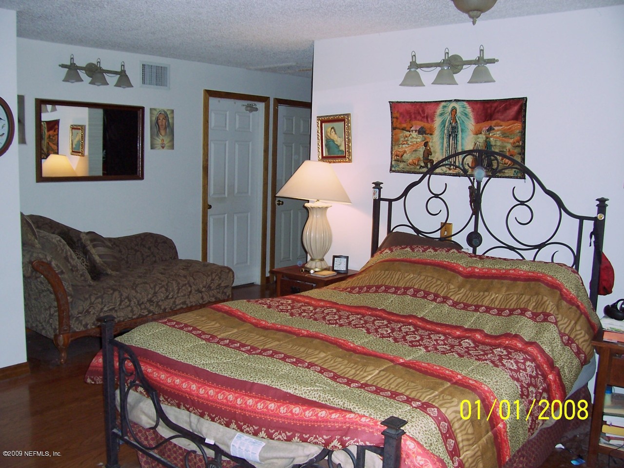 44170 Commanchee Road Callahan, FL 32011 - Photo 4 of 5 a bedroom with a bed and dresser with mirror