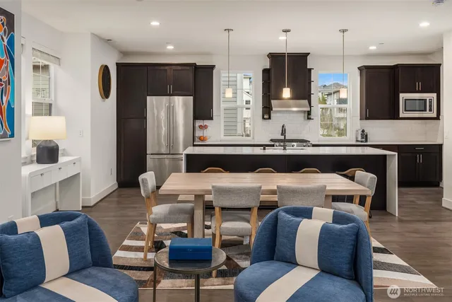 a living room with stainless steel appliances kitchen island granite countertop furniture and a kitchen view