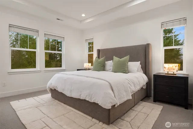 a spacious bedroom with a bed and a window