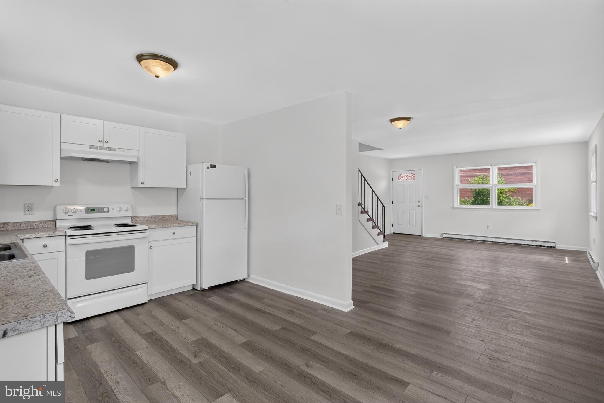 351 Calvert Street Chestertown, MD 21620 - Photo 5 of 19 a kitchen with a white cabinets and wooden floor