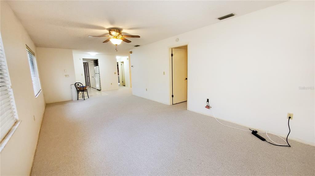 603 Baldwin Avenue, Unit B Safety Harbor, FL 34695 - Photo 7 of 32 a view of a living room with furniture and a ceiling fan
