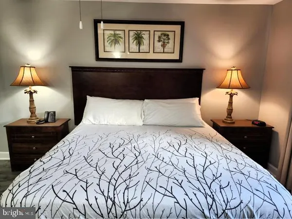 a bedroom with a bed and a lamp