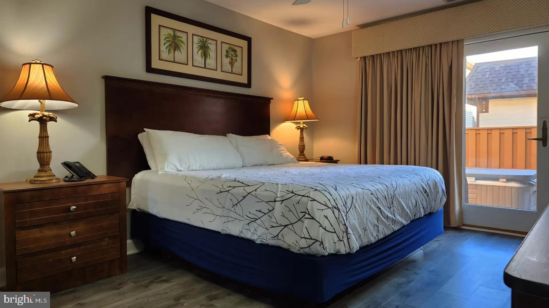 105 Edward Taylor Road, Unit 273 39 Ocean City, MD 21842 - Photo 15 of 23 a bedroom with a bed and a lamp on dresser