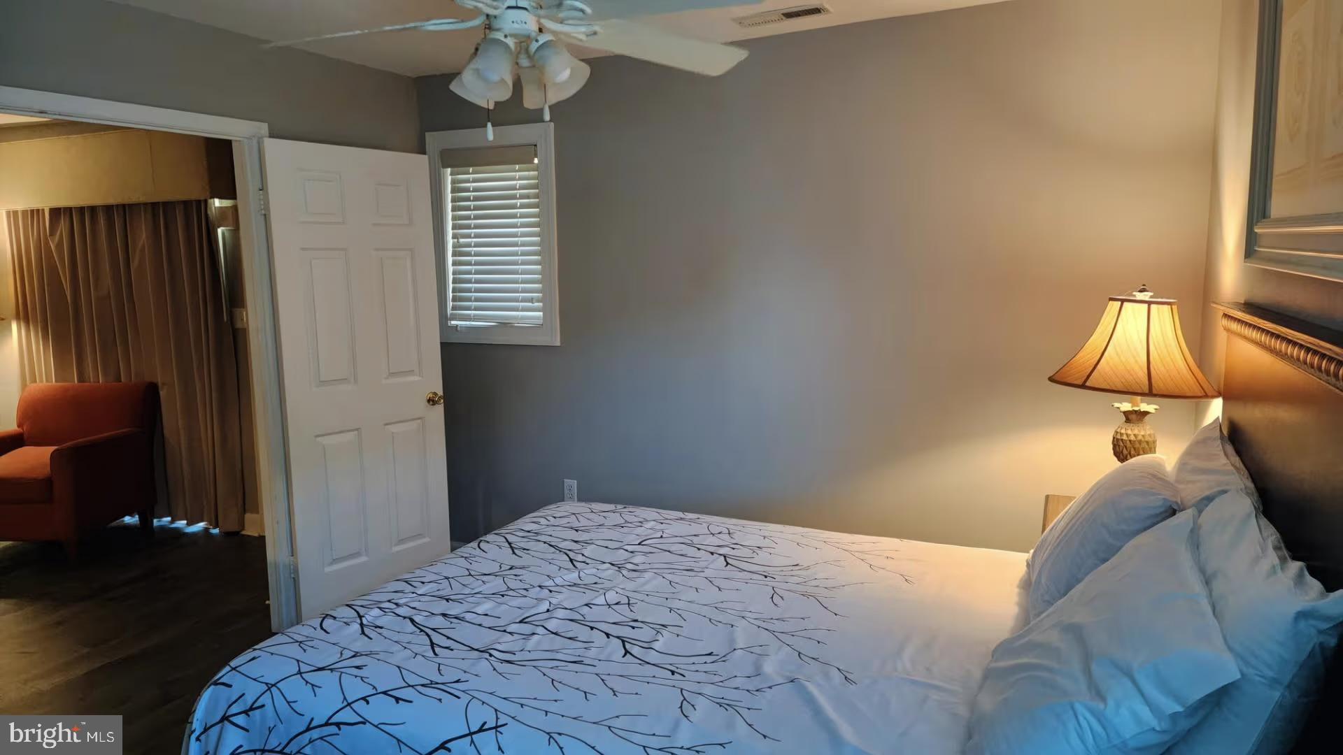 105 Edward Taylor Road, Unit 273 39 Ocean City, MD 21842 - Photo 17 of 23 a bedroom with a bed and a lamp on the table