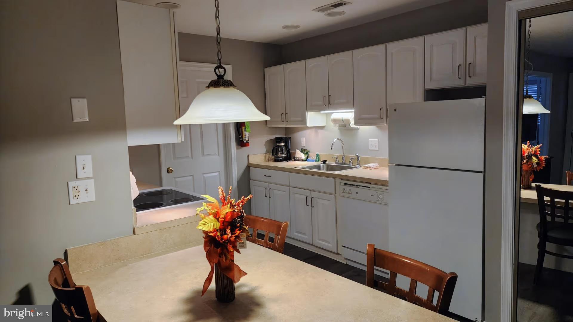 105 Edward Taylor Road, Unit 273 39 Ocean City, MD 21842 - Photo 20 of 23 a kitchen with stainless steel appliances kitchen island a refrigerator sink and cabinets