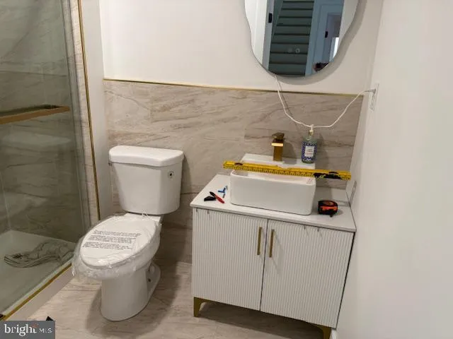a kitchen with stainless steel appliances a sink and a refrigerator