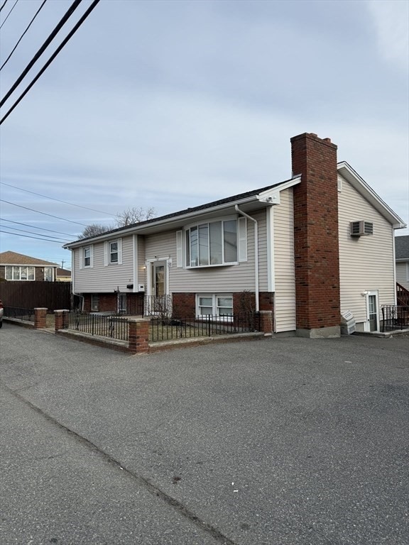 83 Pemberton Street, Unit A Revere, MA 02151 - Photo 1 of 13 a view of a house with a patio and a garage