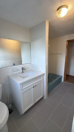 a bathroom with a sink and mirror