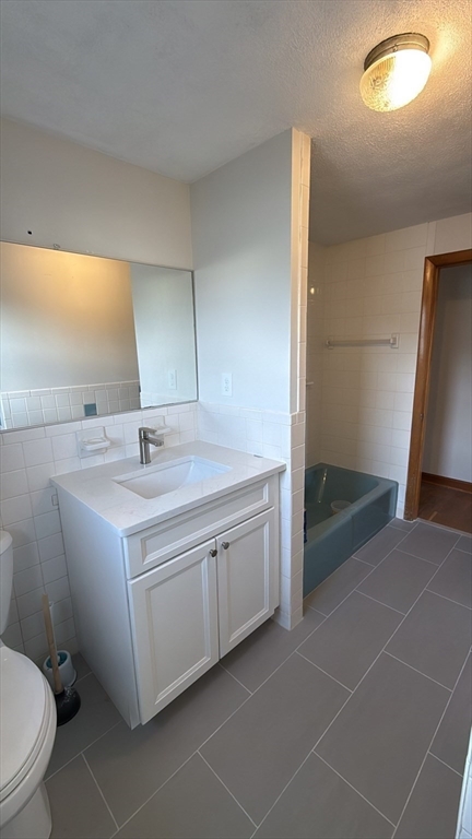 83 Pemberton Street, Unit A Revere, MA 02151 - Photo 12 of 13 a bathroom with a sink and mirror