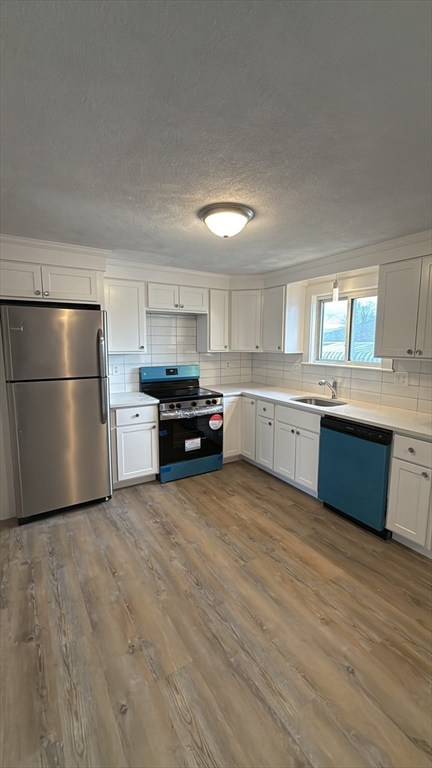 83 Pemberton Street, Unit A Revere, MA 02151 - Photo 2 of 13 a large kitchen with stainless steel appliances granite countertop a stove a sink dishwasher and a refrigerator