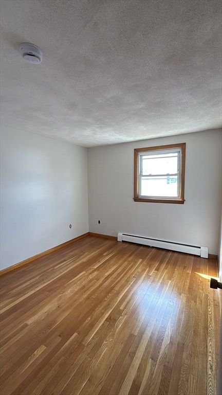 83 Pemberton Street, Unit A Revere, MA 02151 - Photo 9 of 13 a view of a room with wooden floor and window