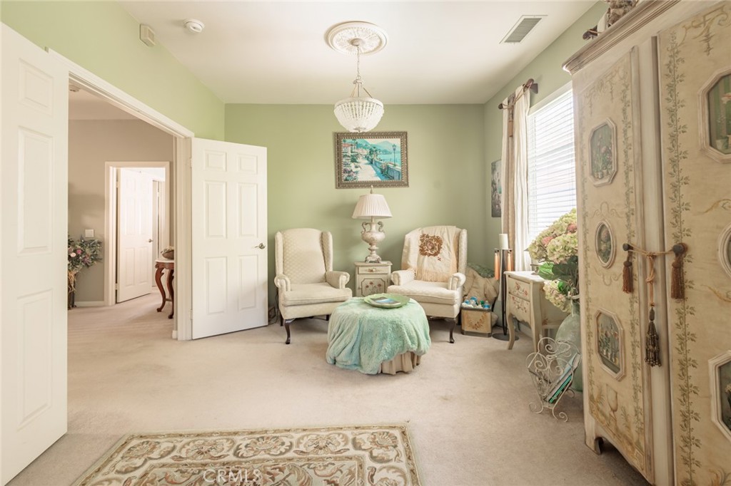1045 Inverlochy Drive Fallbrook, CA 92028 - Photo 15 of 39 a living room with furniture chandelier and a rug
