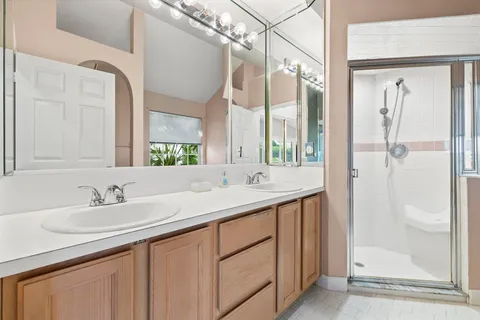 a bathroom with a double vanity sink and a mirror