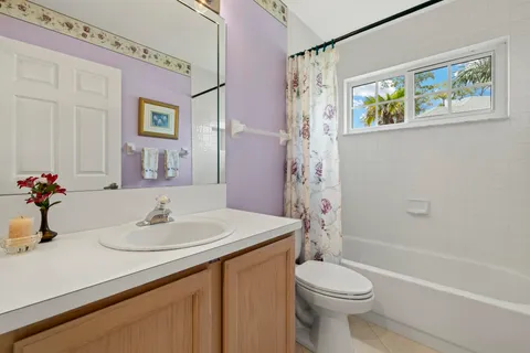 a bathroom with a sink toilet and a mirror