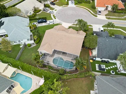 an aerial view of a house with a yard and lake view