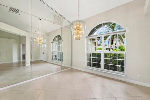 a view of a livingroom with furniture and floor to ceiling window