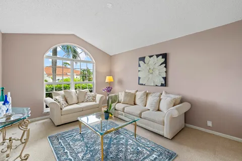 a view of a hallway with kitchen and dining area