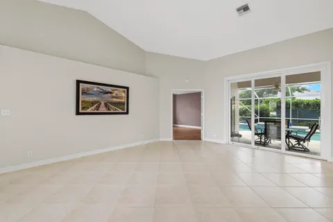 a dining room with furniture a chandelier and window