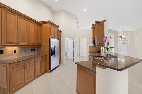 a kitchen with stainless steel appliances granite countertop a refrigerator and cabinets