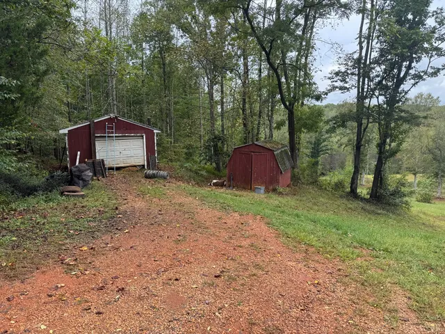a view of a barn in the middle of a yard