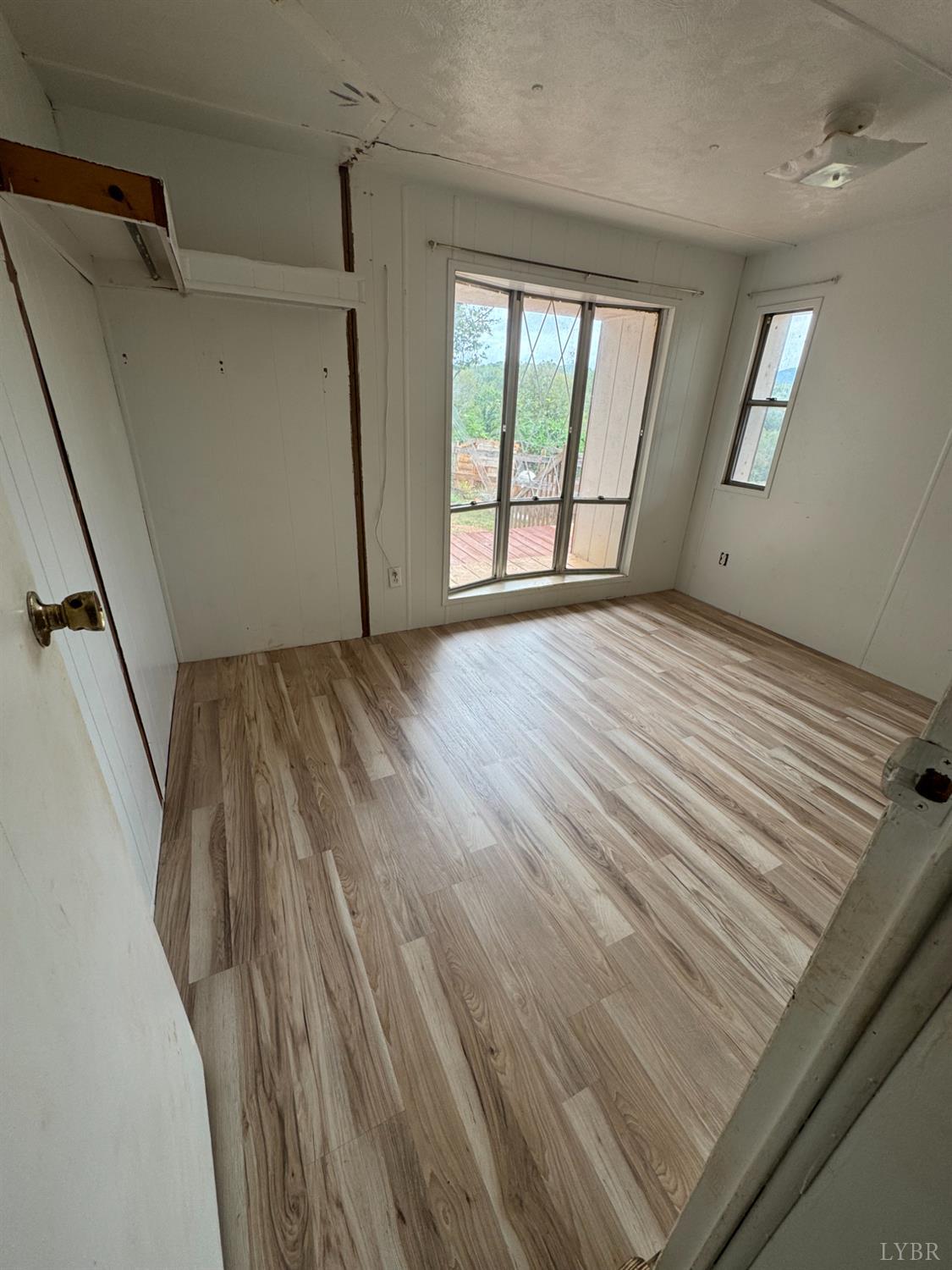 2417 Hunting Lodge Road Schuyler, VA 22969 - Photo 10 of 24 a view of an empty room with wooden floor and a window