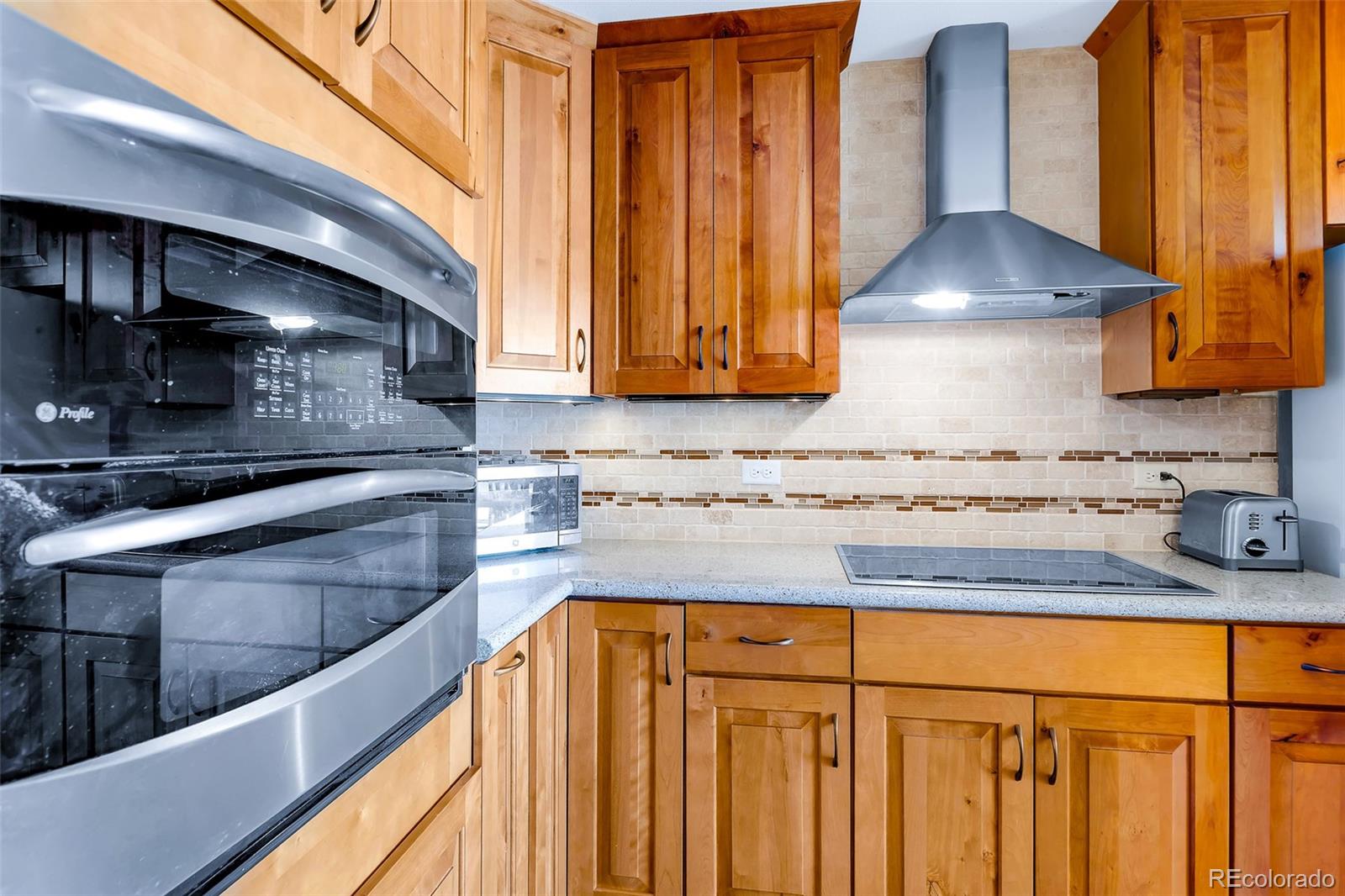 60 Jackson Alma, CO 80420 - Photo 11 of 49 a kitchen with granite countertop wooden cabinets a sink and a stove