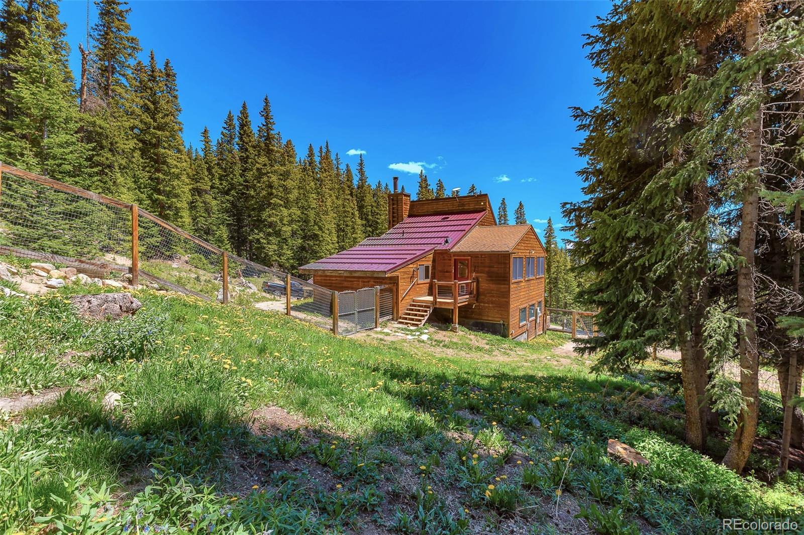 60 Jackson Alma, CO 80420 - Photo 30 of 49 a aerial view of a house with table and chairs under an umbrella