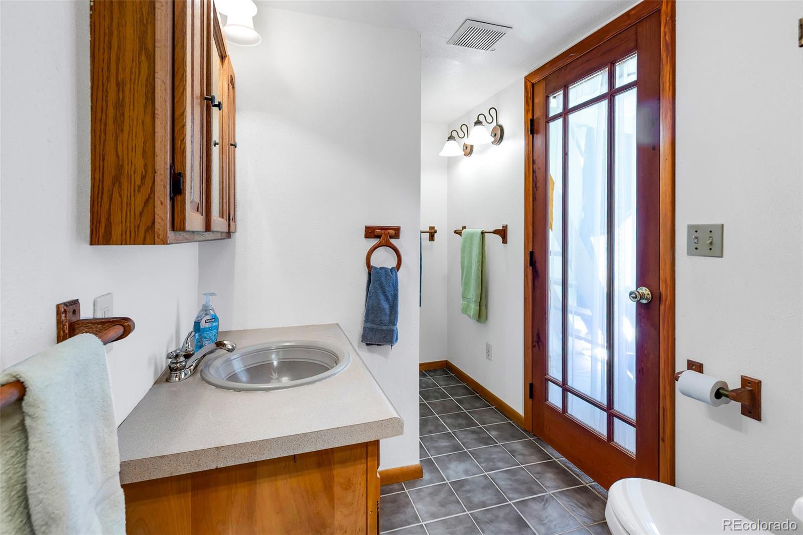 60 Jackson Alma, CO 80420 - Photo 33 of 49 a bathroom with a sink a toilet and mirror