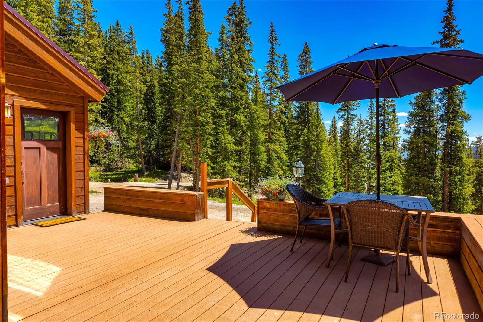 60 Jackson Alma, CO 80420 - Photo 40 of 49 a view of a roof deck with table and chairs under an umbrella with wooden floor