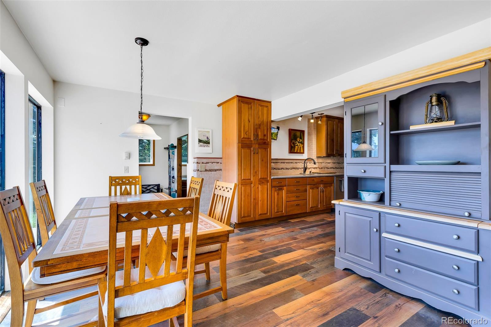 60 Jackson Alma, CO 80420 - Photo 7 of 49 a kitchen with stainless steel appliances granite countertop a refrigerator a stove and a dining table with wooden floor