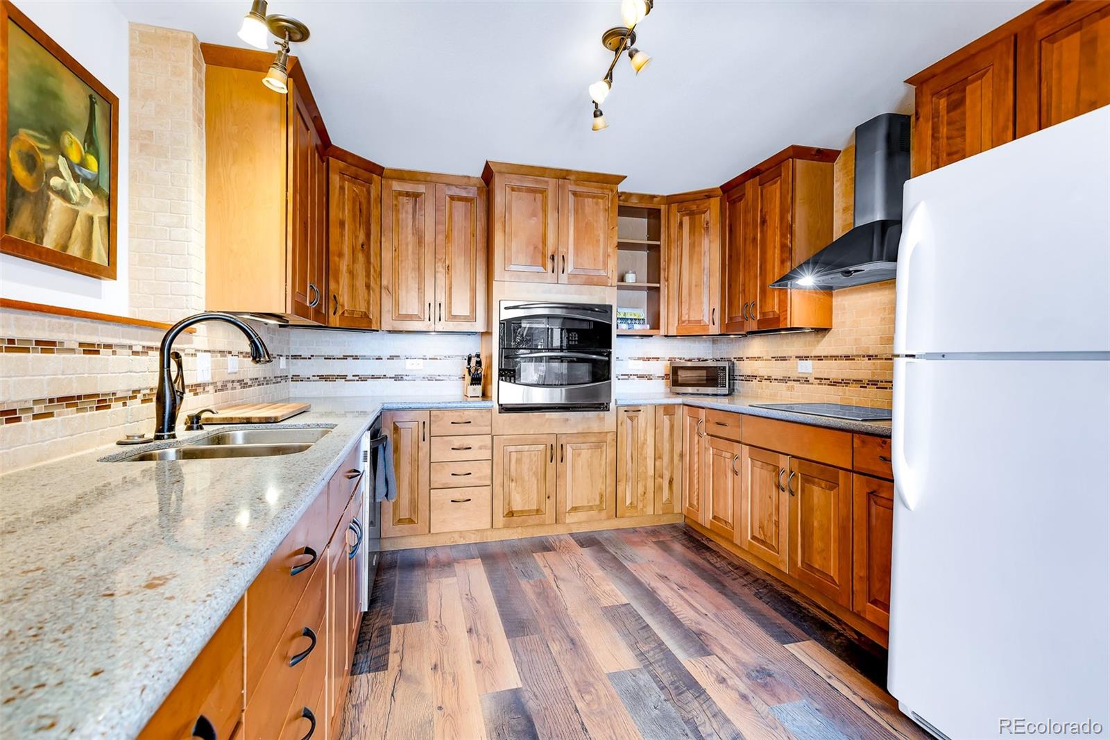 60 Jackson Alma, CO 80420 - Photo 9 of 49 a kitchen with stainless steel appliances granite countertop a stove a sink dishwasher and a refrigerator with wooden floor