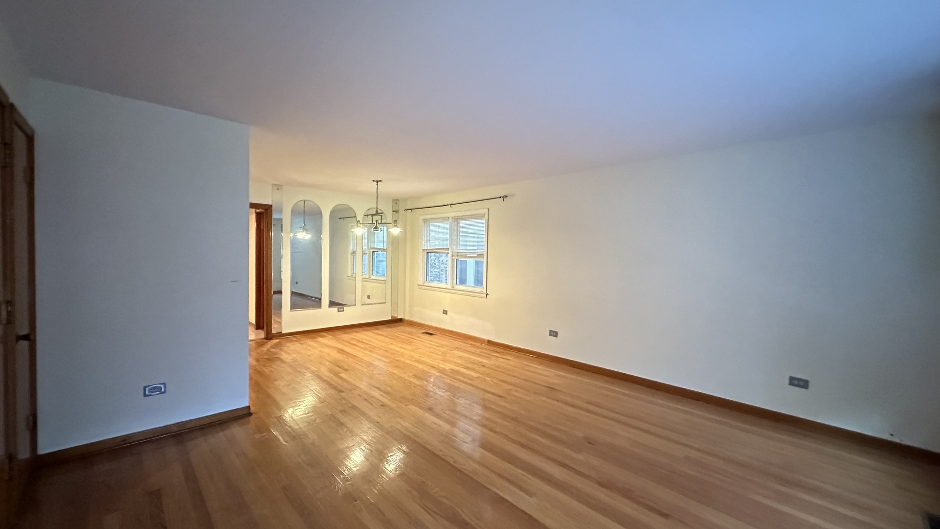 5728 North McVicker Avenue, Unit 1 Chicago, IL 60646 - Photo 2 of 8 a view of an empty room with wooden floor and a window