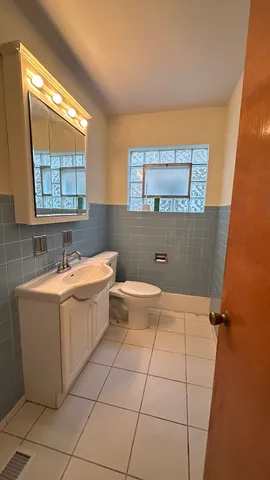 a bathroom with a bathtub sink mirror and toilet