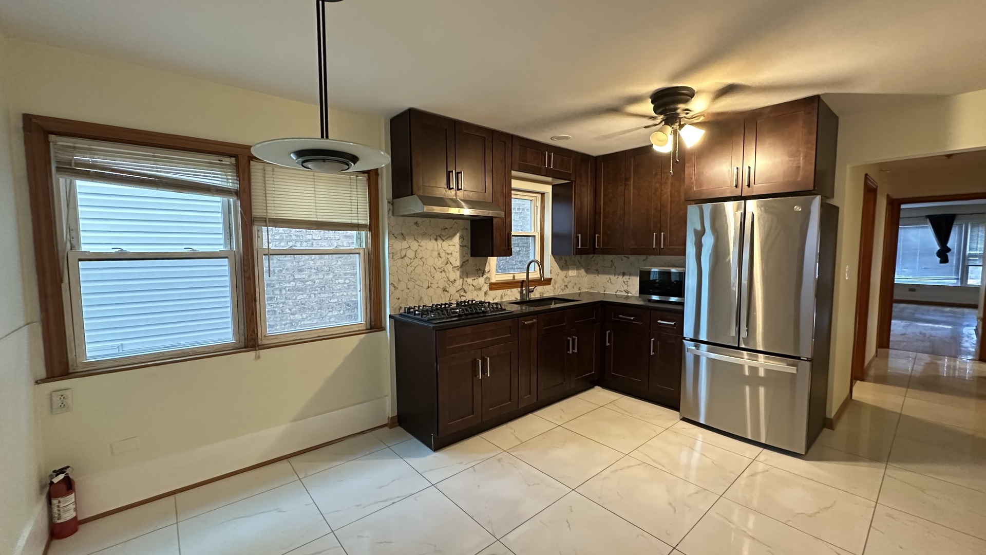 5728 North McVicker Avenue, Unit 1 Chicago, IL 60646 - Photo 7 of 8 a kitchen with stainless steel appliances granite countertop a refrigerator and a sink