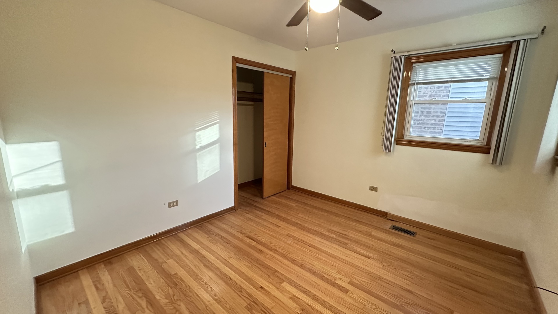 5728 North McVicker Avenue, Unit 1 Chicago, IL 60646 - Photo 8 of 8 a view of an empty room with window and wooden floor