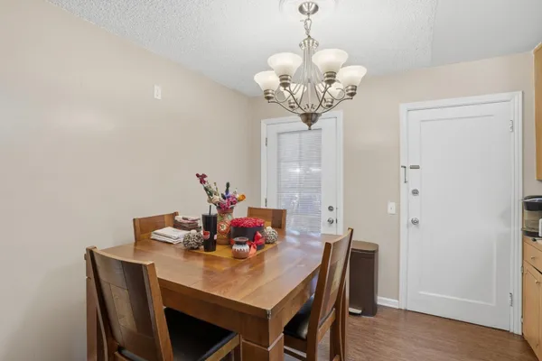 a view of a dining room with furniture wooden floor and chandelier