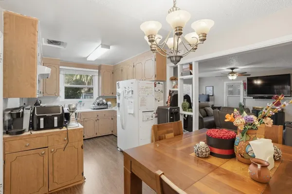 a kitchen that has a lot of cabinets and refrigerator