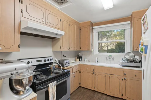 a kitchen with stainless steel appliances granite countertop a sink stove and cabinets
