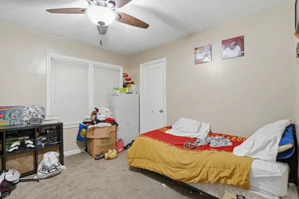 a bedroom with bed and a chandelier