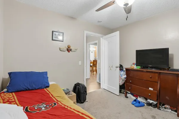 a bedroom with a bed and flat screen tv