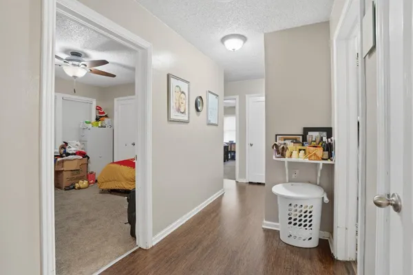 a view of a hallway with wooden floor