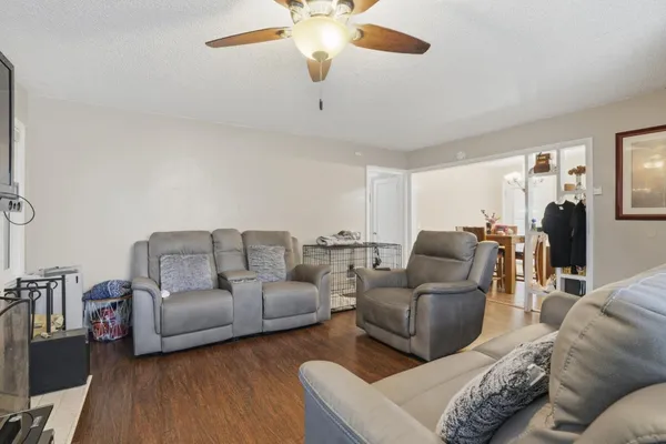 a living room with furniture and a chandelier